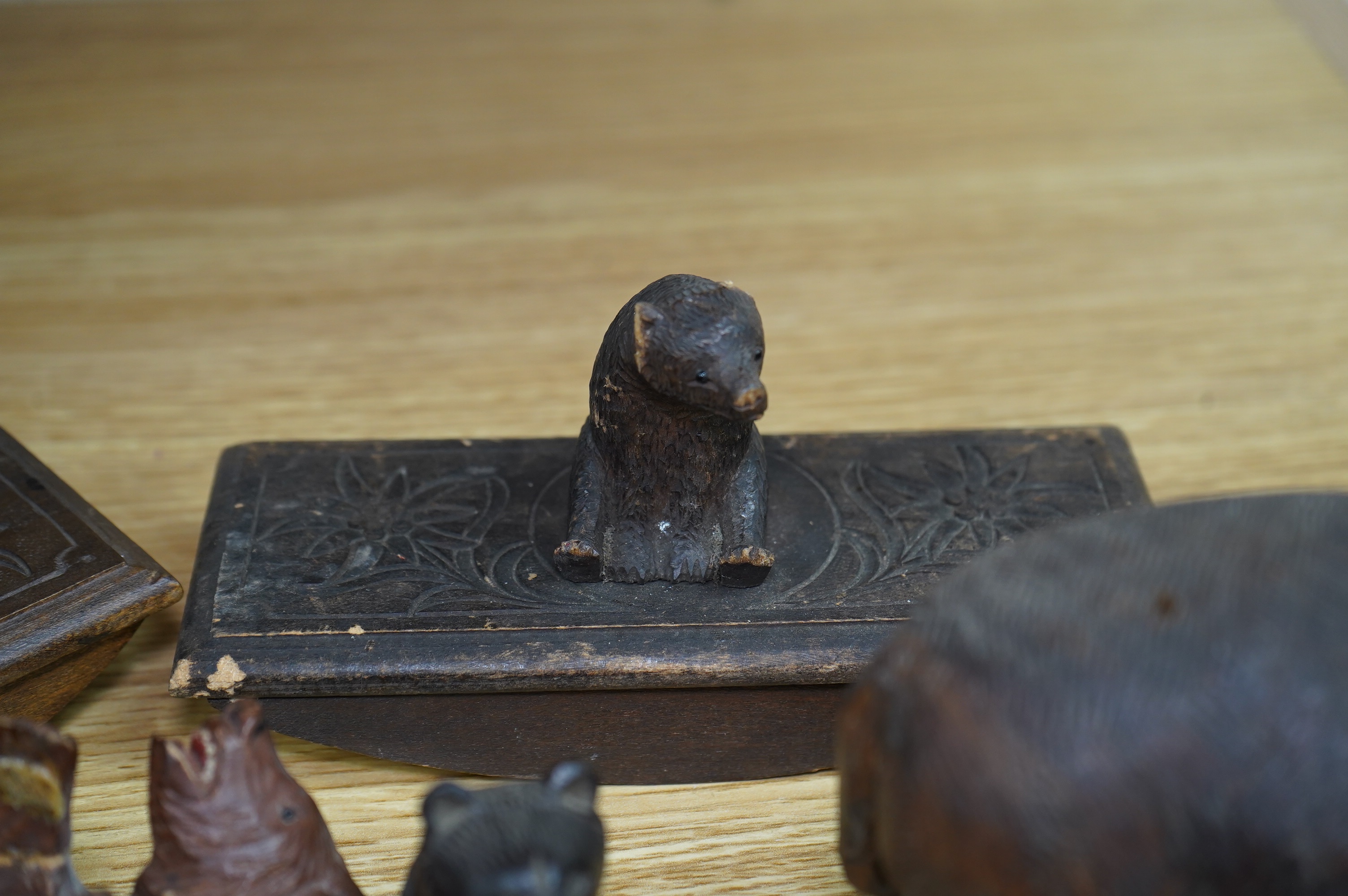 Five carved Black Forest bears, two in the form of ink blotters, together with an African figure of a hippopotamus, largest 17cm wide. Condition - poor to fair